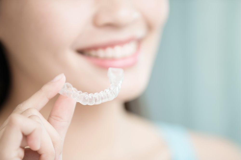 Woman with clear dental retainer